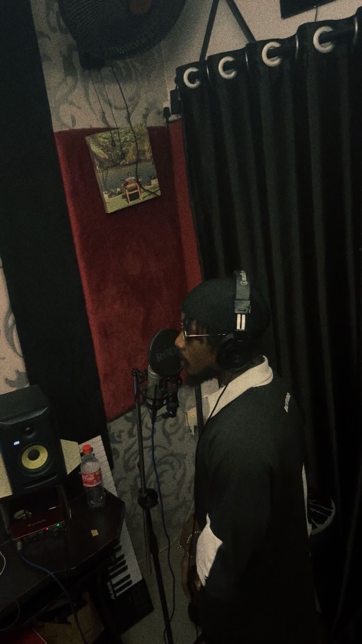 Uthmanzi recording vocals in a studio
